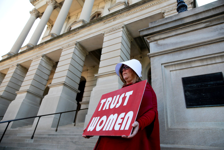 Image: Michelle Disher, dressed as a Handmaid, protests Georgia's anti-abortion \"heartbeat\" bill at the State Capitol in Atlanta on May 7, 2019.