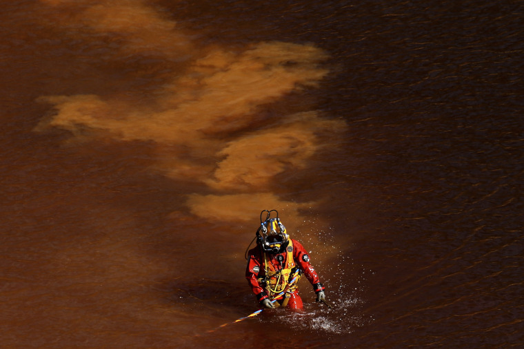 Image: A diver walks through a toxic, man-made lake after searching for a victim of a suspected serial killer in Nicosia, Cyprus, on May 8, 2019.