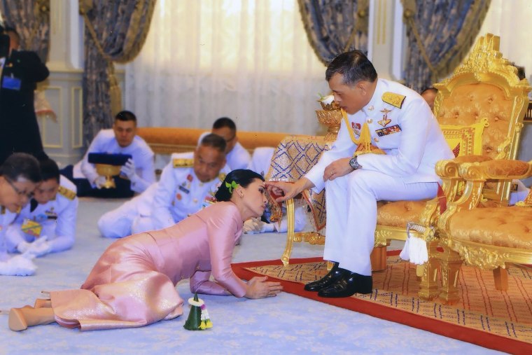 Image: Thailand's King Maha Vajiralongkorn touches the face of his new wife, Queen Suthida, during their wedding ceremony in Bangkok on May 1, 2019.
