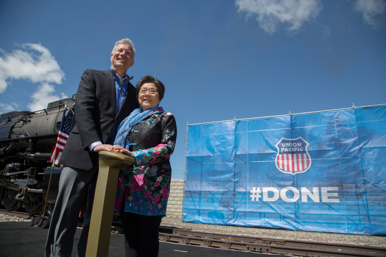 Lance M. Fritz. Chairman, President and CEO Union Pacific Corporation and Margaret Yee, a Chinese-American whose great grandfathers worked on the railroad pose with a "golden spike" in Ogden, Utah.
