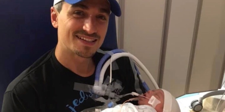 Matthew Accurso, holding his newborn son, for the first time.