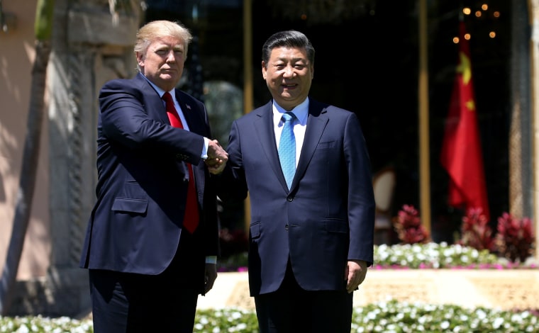 Image: U.S. President Trump and China's President Xi  shake hands during walk at the Mar-a-Lago estate after a bilateral meeting in Palm Beach