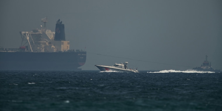 Image: A coast guard vessel passes an oil tanker off the coast of Fujairah, United Arab Emirates