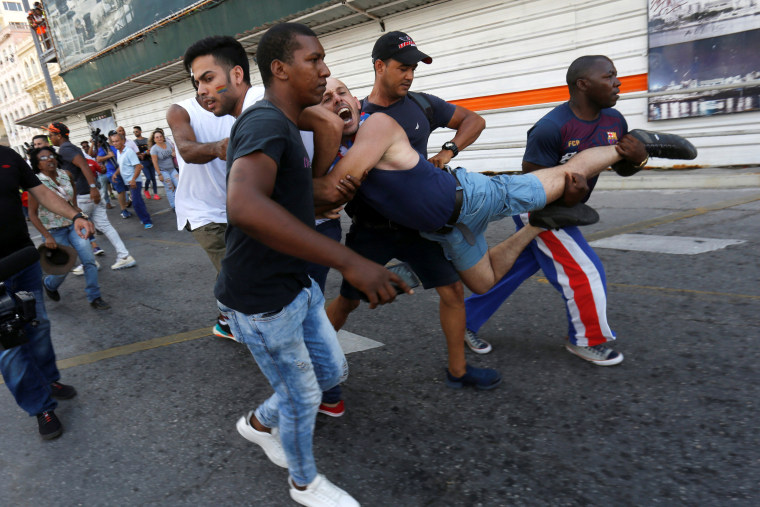 Image: An LGBT activist is detained by plain-clothed security personnel during a demonstration in Havana on May 11, 2019.