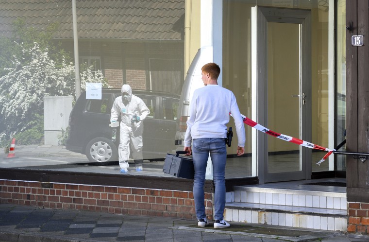 Image: A police officer investigates the scene where the bodies of two women were found dead in Wittigen, Germany, on May 13, 2019.