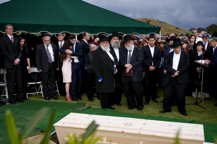 Image: Hannah Kaye, along with Jewish community leaders and mourners, stand near the coffin of her mother, Lori Kaye, at El Camino Cemetery in San Diego, California, on April 29, 2019. Lori Kaye was fatally shot at a synagogue in Poway.