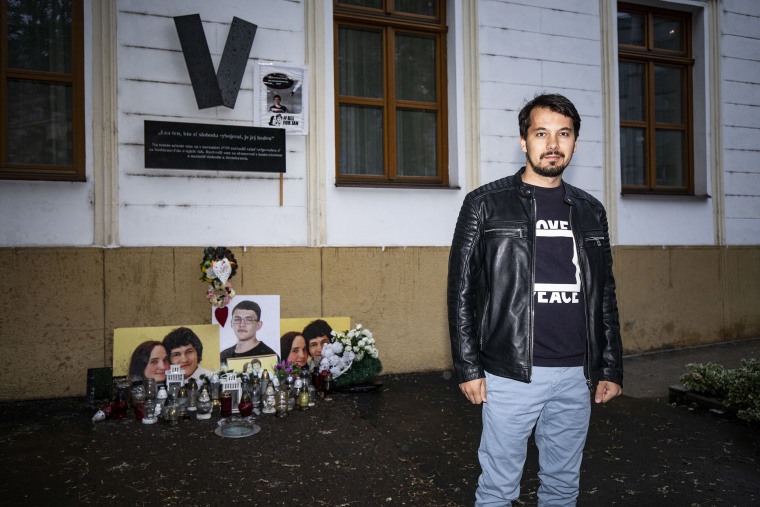 Image: Juraj Seliga stands next to a memorial for murdered journalist Jan Kuciak and his fiancee, Martina Kušnírová, in Bratislava