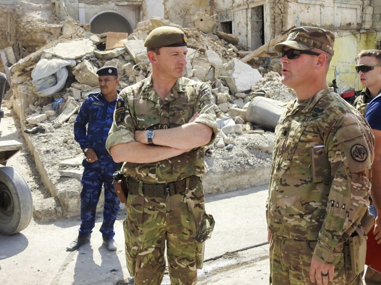 Image: Army Lt. Col. CJ Kirkpatrick, right, a squadron commander with 3rd Cavalry Regiment, escorts British Maj. Gen. Christopher Ghika, Combined Joint Task Forces Operation Inherent Resolve Deputy Commander, through the streets of Mosul to observe the de