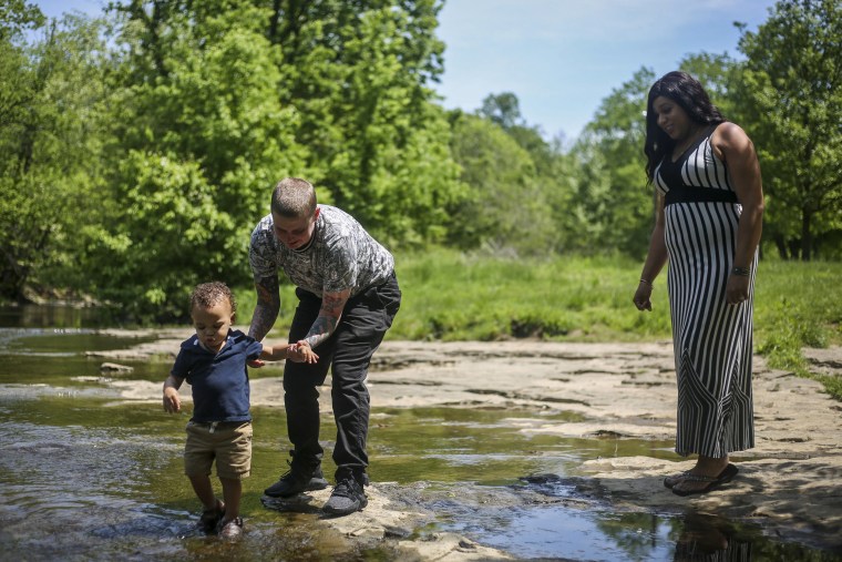 Image: Jay Thomas helps son Dorian Brewster-Thomas, 2, play in the water as Jamie Brewster watches in Big Rock Park in Louisville, Kentucky, on Tuesday, May 7, 2019.
