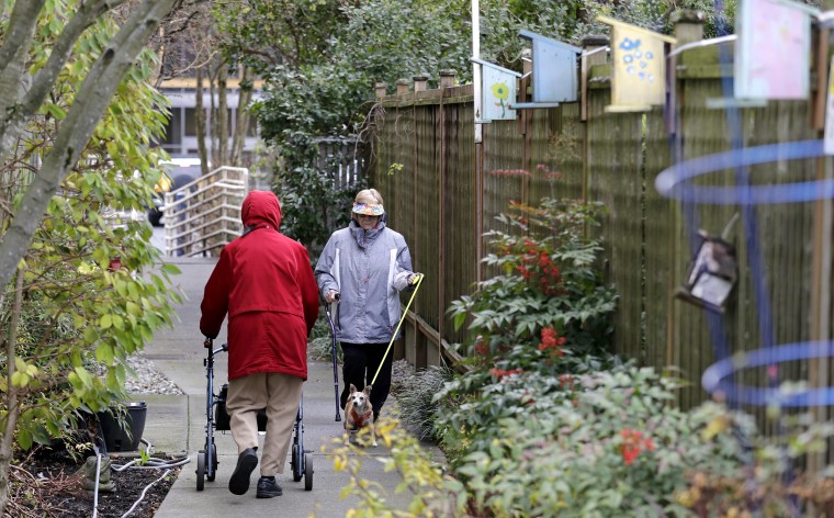 Image: Senior housing residents walk before a news conference on housing in Seattle in December 2018. Mayor Jenny Durkan says the housing investment puts the city on target to make nearly 4,000 new homes available by 2022.