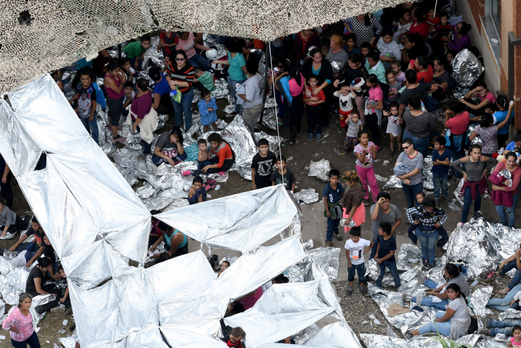 Image: Migrants are seen outside the U.S. Border Patrol McAllen Station in a makeshift encampment in McAllen