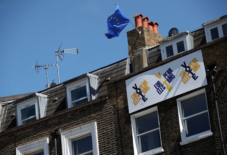 Image: A European Union flag flies and a Vote European Election sign hangs from a house in south London
