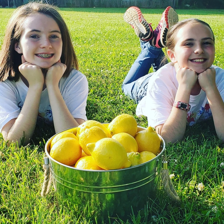 Hailey, left, and her sister Hannah make and sell lemonade to pay off their school's debt.