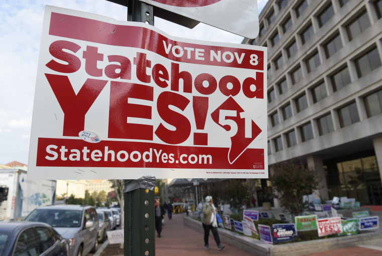 Image: Signs supporting DC statehood are on display outside an early voting place on in Washington