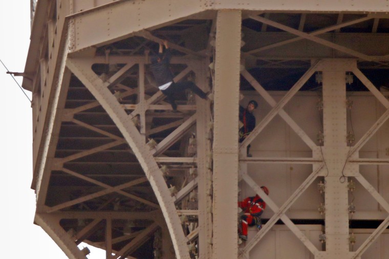 Image: Unidentified man climbs the Eiffel Tower in Paris