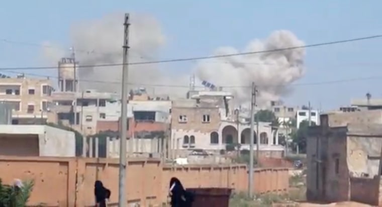 Image: Plumes of smoke rising from a town, said to be Saraqib, Idlib province, Syria