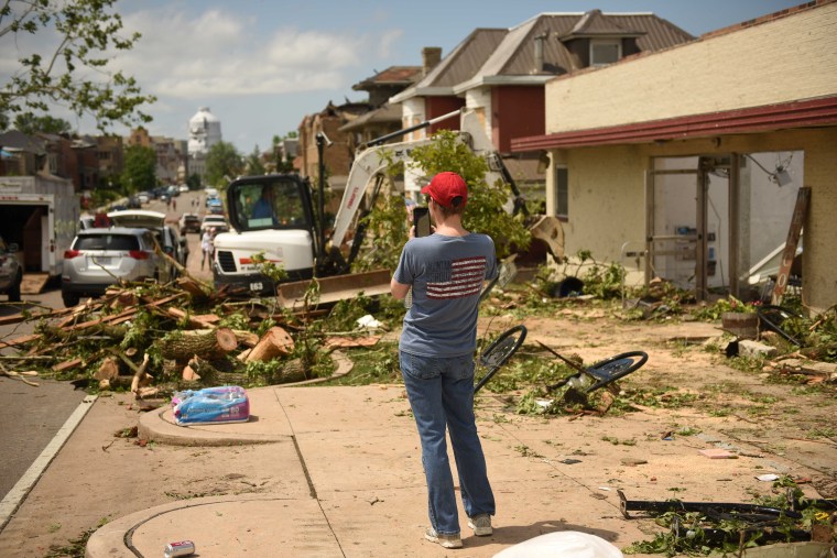 Image: A Jefferson City resident takes photos of debris following a tornado touchdown overnight in Jefferson City, Missouri, U.S. May 23, 2019.