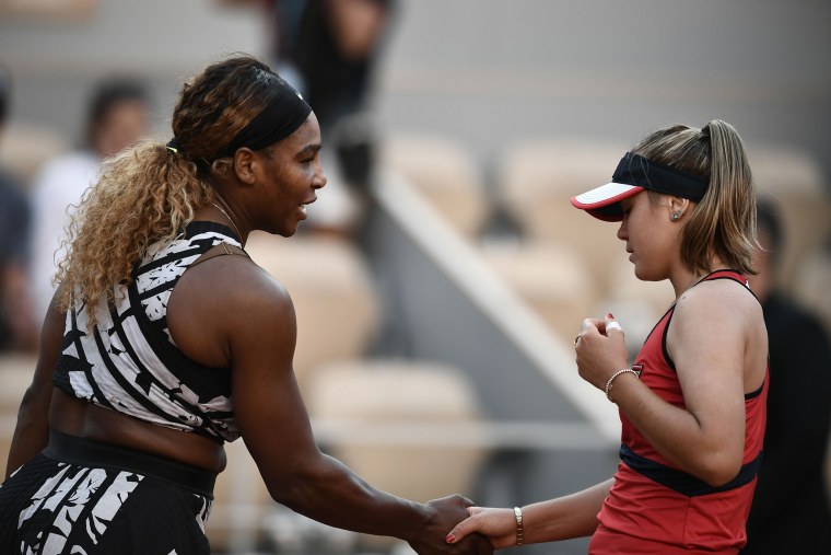 Serena Williams and Sofia Kenin shake hands at the end of their women's singles third round match on day seven of The Roland Garros 2019 French Open tennis tournament in Paris on June 1, 2019.