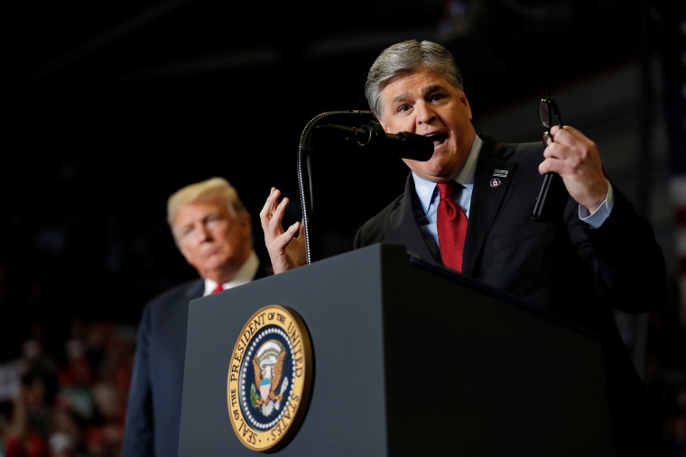 Image: U.S. President Donald Trump listens as Sean Hannity from Fox News speaks at a campaign rally in Missouri