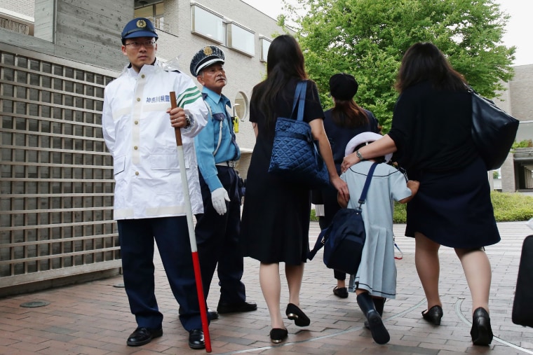 Image: Children and their parents arrive at the elementary school in Kawasaki, Japan