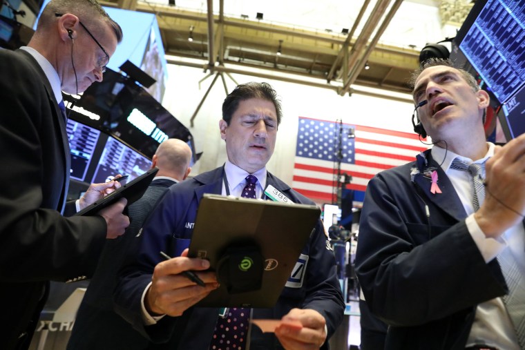 Image: Traders work on the floor at the NYSE in New York