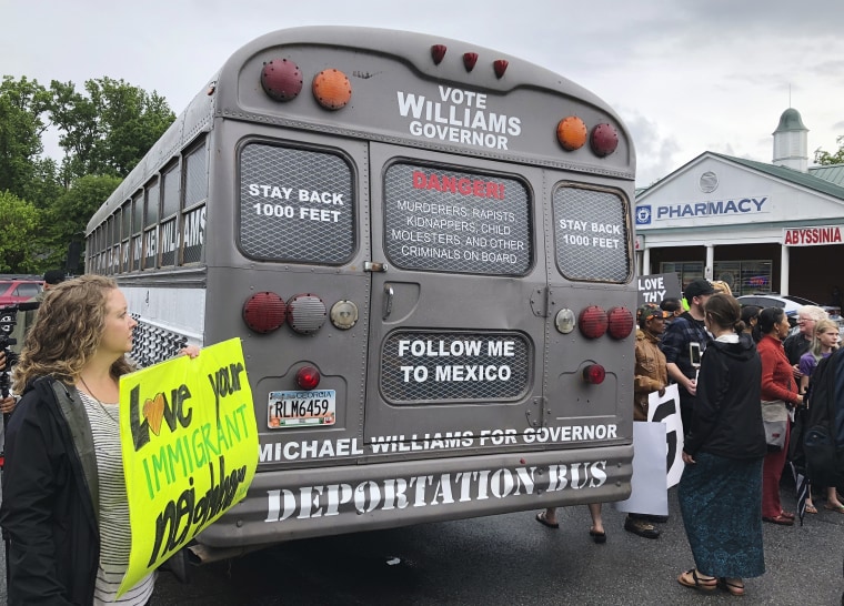 Protesters surround the bus used for state Sen. Michael Williams' Georgia gubernatorial election campaign in Clarkston, Georgia