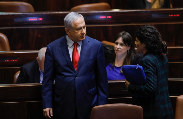 Image: Israeli Prime Minister Benjamin Netanyahu stands during a vote on a bill to dissolve the Knesset