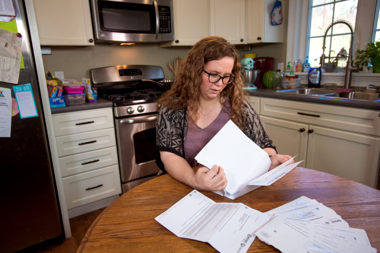 Image: Jessica Evers looks through a stack of letters she's received about her student loans over the years. She has deferred payment, but the interest keeps accumulating.