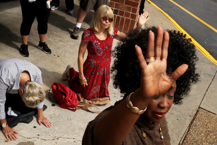 Image: Mourners pray during a vigil the day after 12 people were killed in a shooting at a municipal building in Virginia Beach on June 1, 2019.