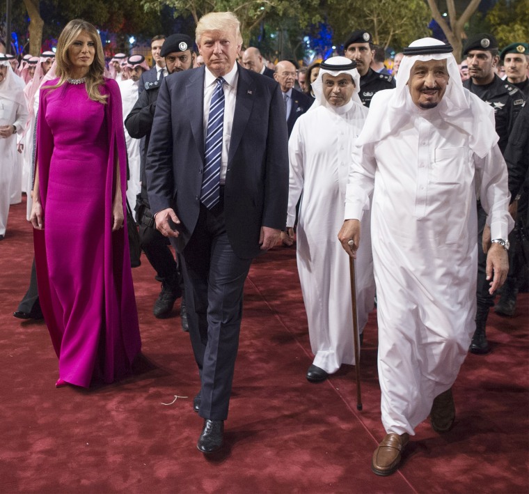 Melania Trump wears a red cape dress for dinner with Prince Charles