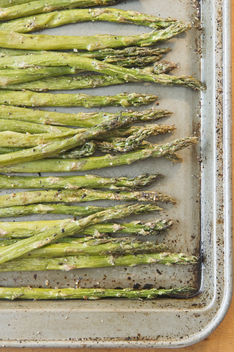 Close up of roasted asparagus on baking sheet