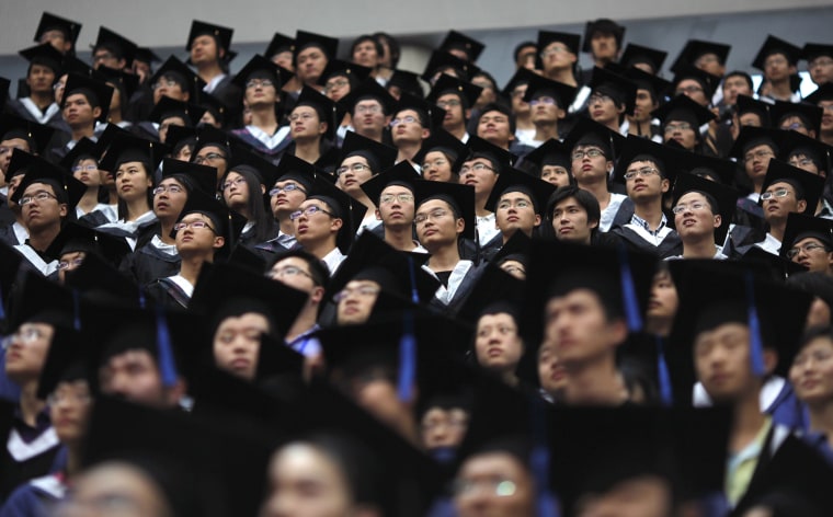Image: Students attend their college graduation ceremony at Fudan University in Shanghai, China