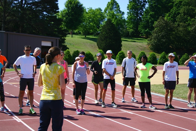 FIRST Adult Running and Learning Retreat participants on the track preparing for a running workout