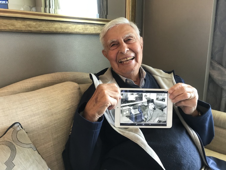 Image: Veteran Peter Orlando holds up a photo of himself during WWII.