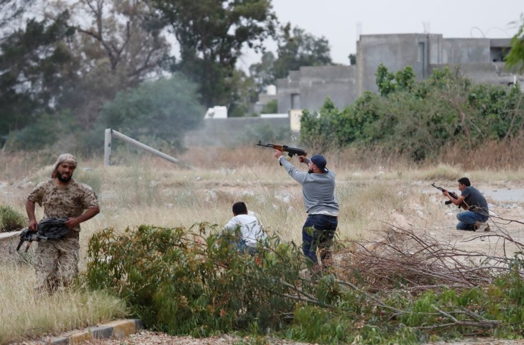 Image: A fighter loyal to Libya's U.N.-backed government (GNA) fires an AK-47 during a clash with forces loyal to Khalifa Haftar at the outskirts of Tripoli