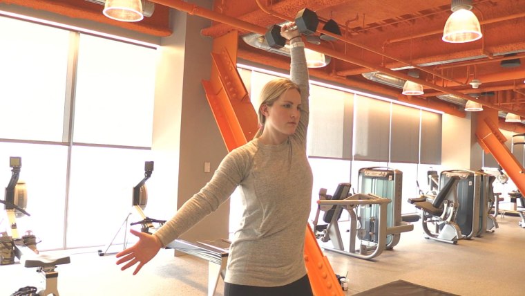 Monique Lamoureux-Morando demonstrating a single arm dumbbell press.