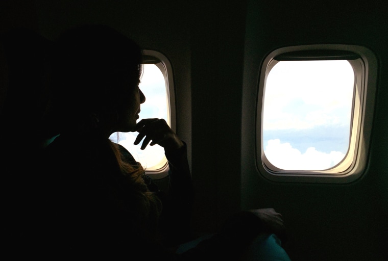 Thoughtful Woman Traveling In Airplane