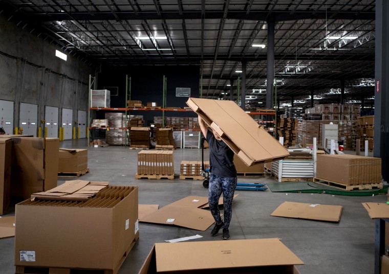 Image: Lidia Berber stacks cardboard boxes at the Tradelink Auto Parts warehouse in Laredo, Texas, on June 8, 2019.