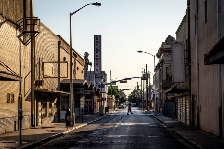 Image: Residents walk through downtown Laredo on June 8, 2019.