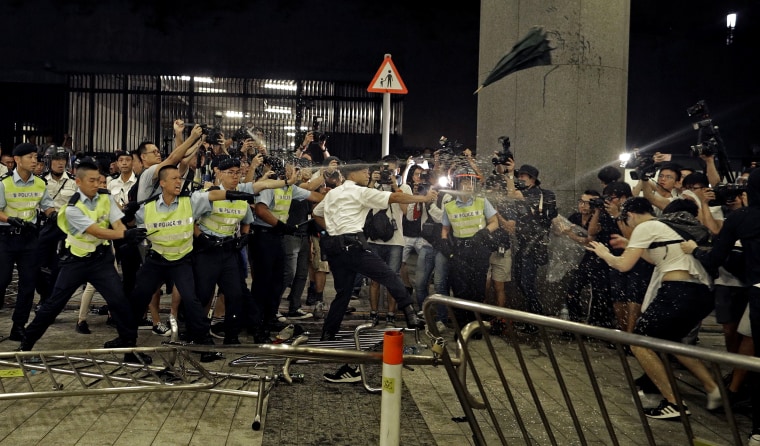 Image: Police officers use pepper spray against protesters in Hong Kong in the early hours of June 10, 2019.