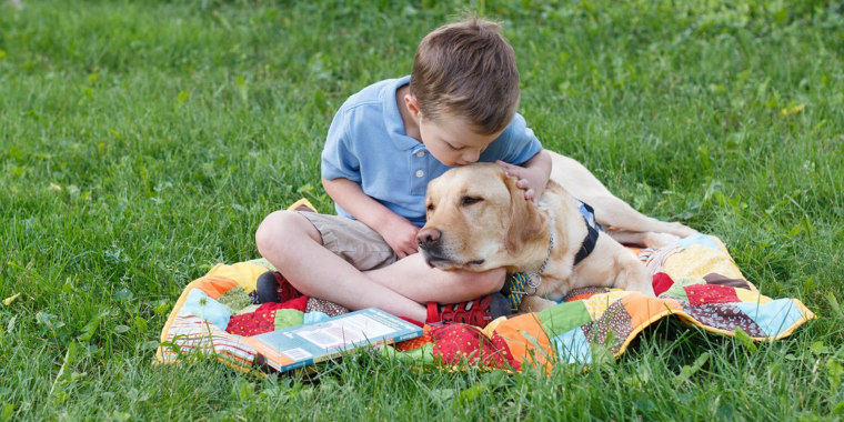 Amanda Swearingen's son Gavin and his service dog "Elmer" at Holiday Park on Sunday June 2, 2019.