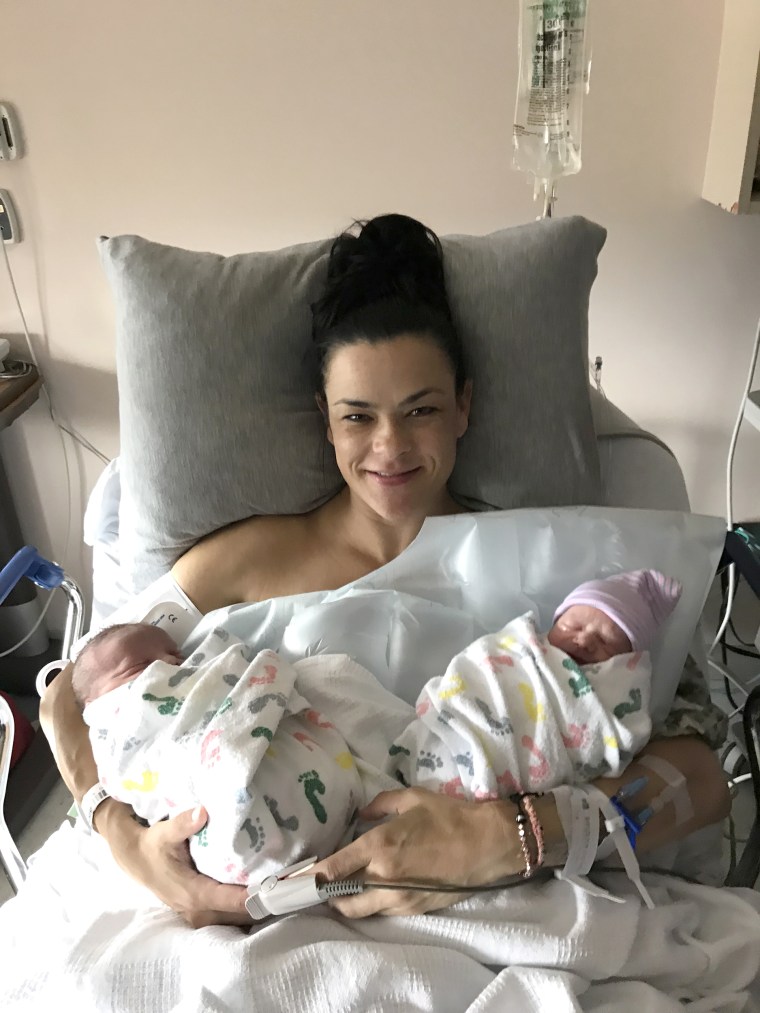 Jill Noe holding twins Rhett and Rhenley.