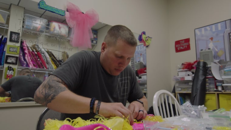Lexington County Sheriff's Department Deputy Dustin Pollard sorts through delicate ribbons and frilly fabric while sewing costumes for his daughter's dance team.