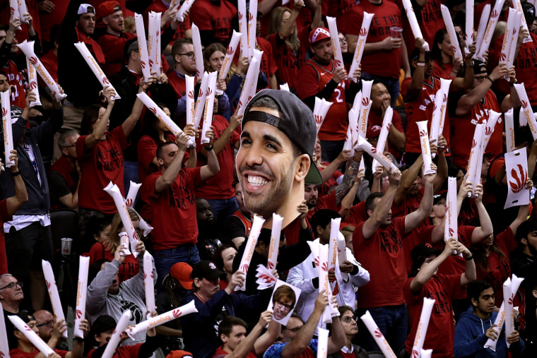 Image: Toronto Raptors fans hold up a photo of Drake during an NBA playoff game against the Milwaukee Bucks on May 25, 2019.