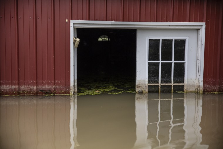 The barn located on Stormy Deere's property, located near Redwood, Mississippi, is surrounded by water due to the heavy flooding in the Mississippi Delta.
