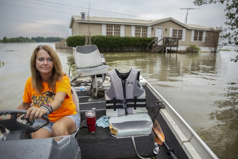 Stormy Deere navigates her boat to dry land near Redwood, Mississippi on June 4, 2019. Deere has lived at her home with her husband Jimmy for 12 years. She has had to use her fishing boat to get to and from her home since early March.