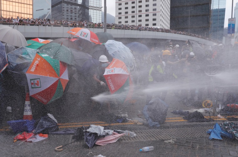 Police fire a water cannon at protesters on Wednesday.