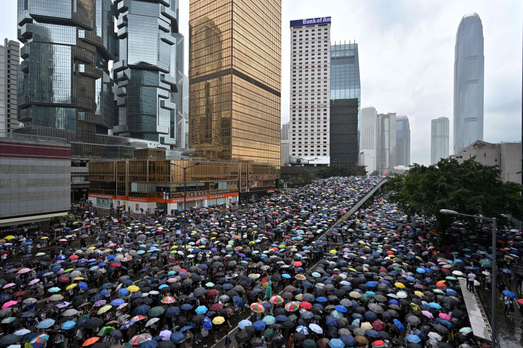 Protesters shelter under umbrellas during a downpour in Hong Kong 