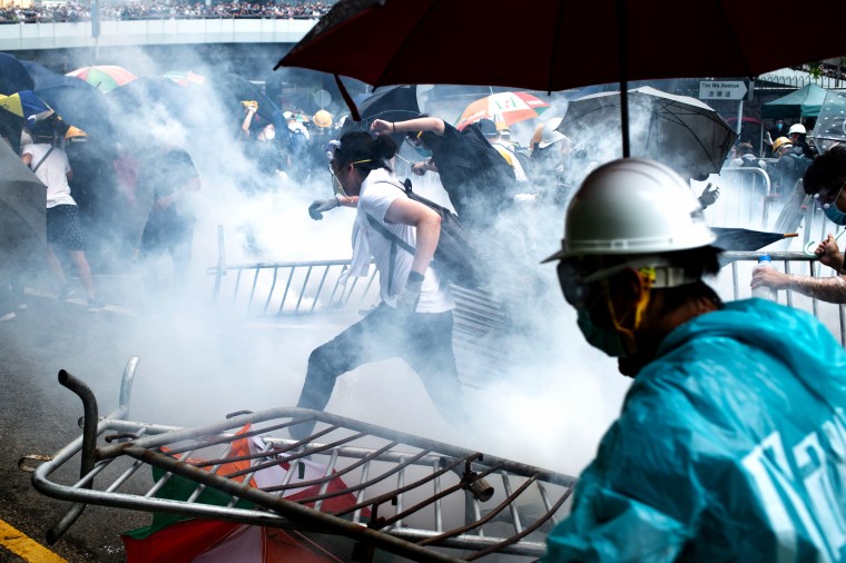 Image: Protesters run after police fired tear gas during a rally outside the government headquarters in Hong Kong on June 12, 2019.