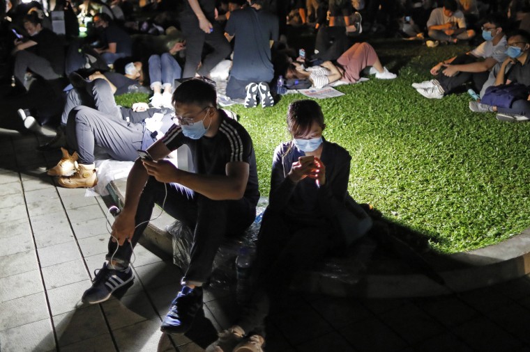 Image: Extradition law protesters browse their smartphones near the Legislative Council in Hong Kong.